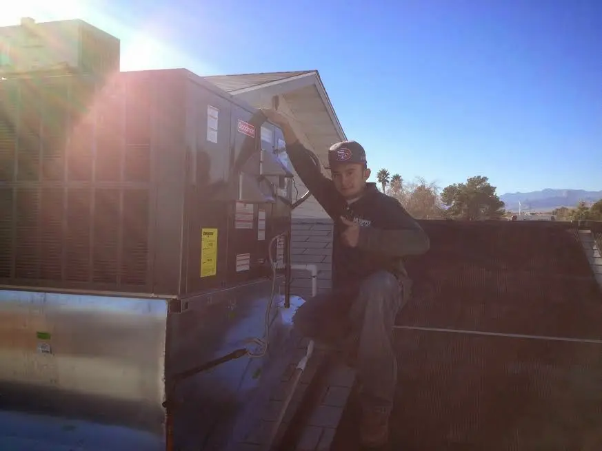 HVAC technician performing HVAC Inspection on a rooftop unit in Laurel Bay